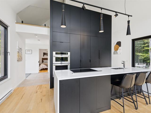 Modern kitchen with dark cabinets and pendant lighting